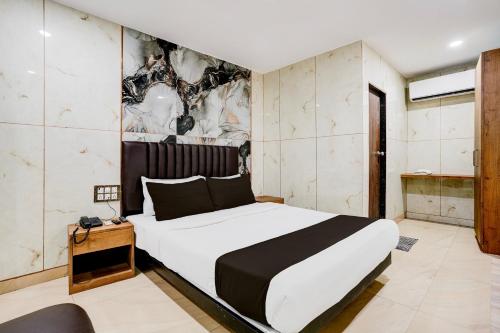 a bedroom with a large white bed in a room at Super Collection O Ulife in Mumbai