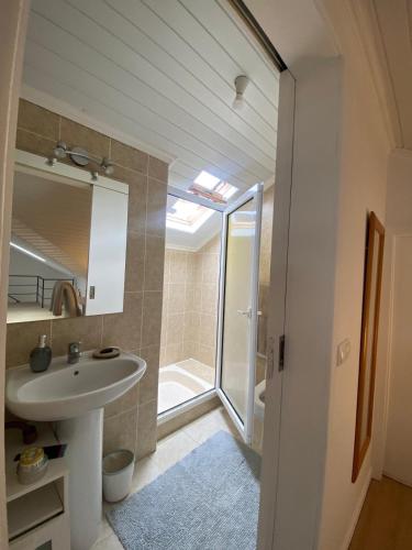 a bathroom with a sink and a shower at Casa do sol in Santa Cruz