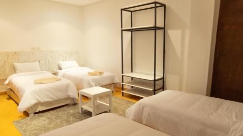 a room with two beds and a mirror in it at Dakhla Experience - Surf House in Dakhla