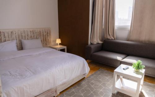 a bedroom with a bed and a couch at Dakhla Experience - Surf House in Dakhla