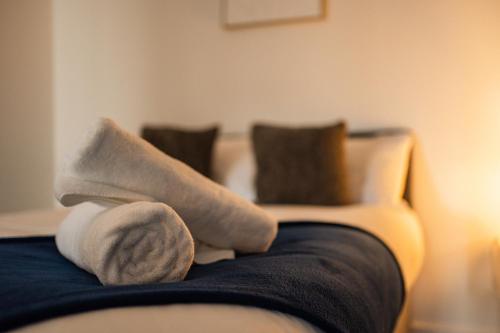a person sitting on a couch with socks on at Legion House Apartment One Middlesbrough in Middlesbrough