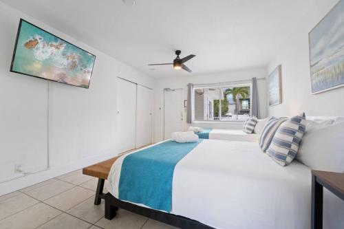 a white bedroom with a bed and a window at Catalina by the Beach 6 in Pompano Beach