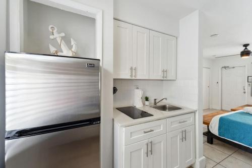 a kitchen with a sink and a refrigerator at Catalina by the Beach 6 in Pompano Beach