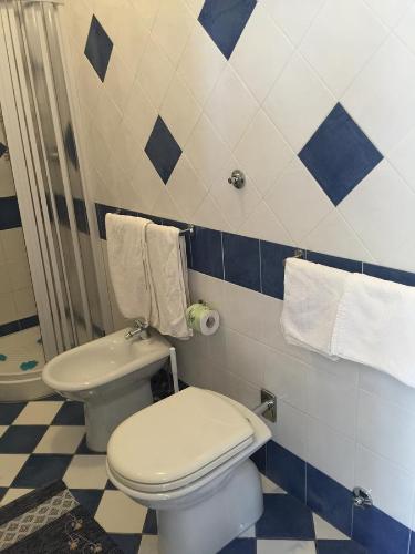 a bathroom with a white toilet and a shower at Holiday Home Gionny & Mary in Taormina