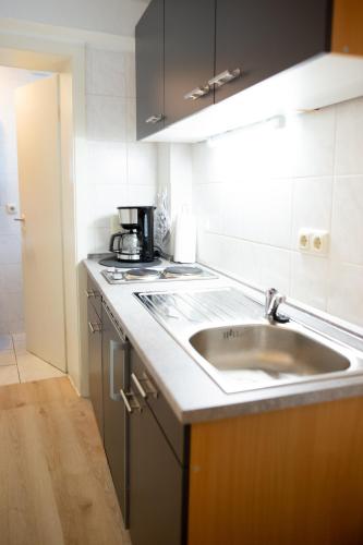 a kitchen with a sink and a coffee maker on the counter at Apartment Astrid in Bad Pyrmont