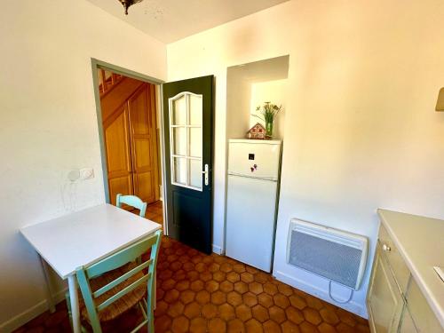 a kitchen with a door and a table and a refrigerator at Vacation House in Quiet Village in Congerville