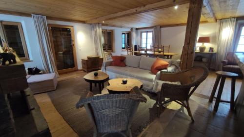 a living room with a couch and a table at Standalone Chalet With Breathtaking Sanetsch View in Gsteig