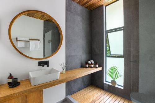 a bathroom with a sink and a mirror at Brand-new luxury Villa Element in Carmen