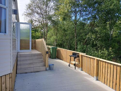 a porch with stairs and a grill on a house at Bella May Mobile Home in Ballintra