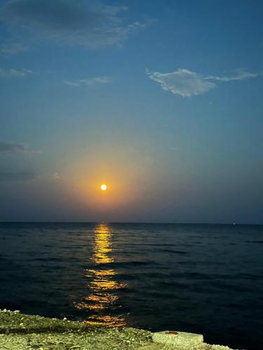 a sunset over the ocean with the sun in the sky at The Aegean balcony in Enoría