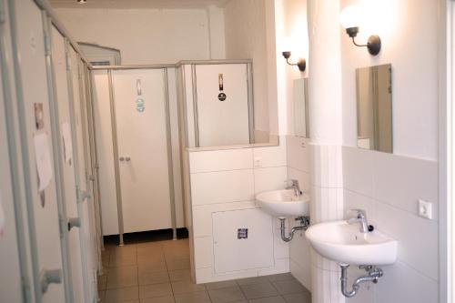 a bathroom with two sinks and a shower at Urban Loft in Vibrant Kreuzkölln in Berlin