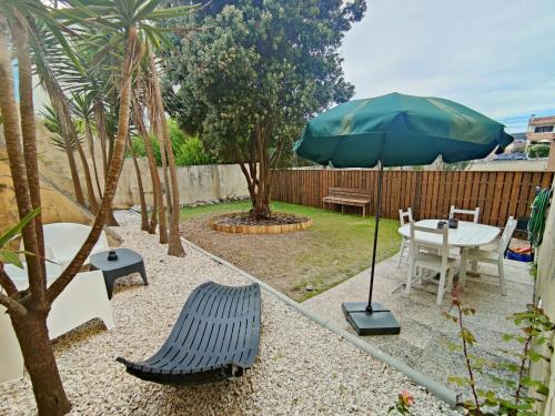 a patio with a table and an umbrella at Casa Amarela in Cortegaça