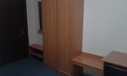 a room with a wooden closet and a wooden cabinet at Vershnyk in Cherkasy
