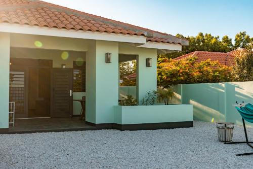 a small house with a patio in a yard at Villa 5 Green Courtyard Village in Kralendijk