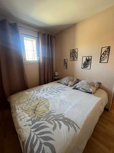 - une chambre avec un lit orné de motifs floraux dans l'établissement Appartement T2 Cosy, à Saint-Éloy-les-Mines