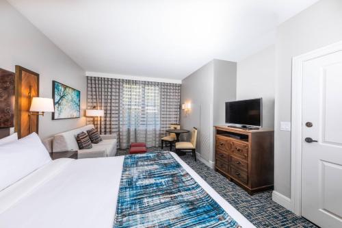 a hotel room with a bed and a flat screen tv at Marriott's Timber Lodge in South Lake Tahoe