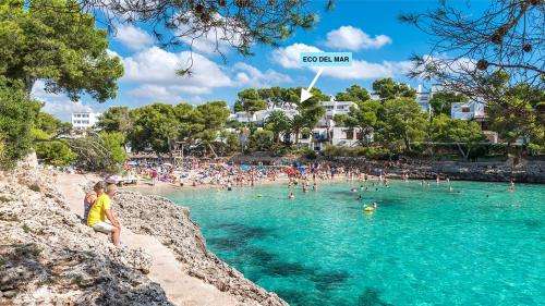 a group of people in the water at a beach at Eco del Mar in Cala d´Or