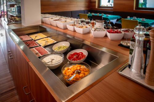 a buffet line with many different types of food at Bed & Breakfast Hostel Nives in Solda