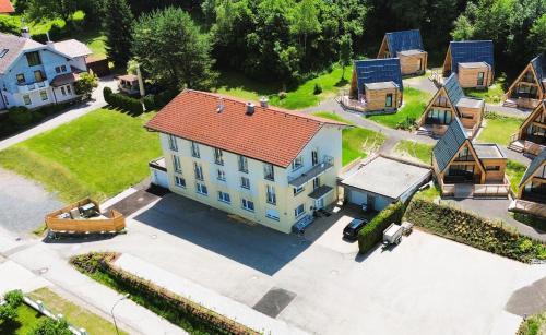 an overhead view of a house with a red roof at Mountains & Lakes - Chaletdorf & Appartements in Villach