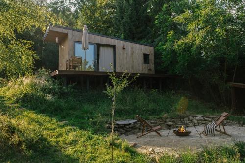 a small cabin in the middle of a forest at hOMM domek nad jeziorem in Stryszów
