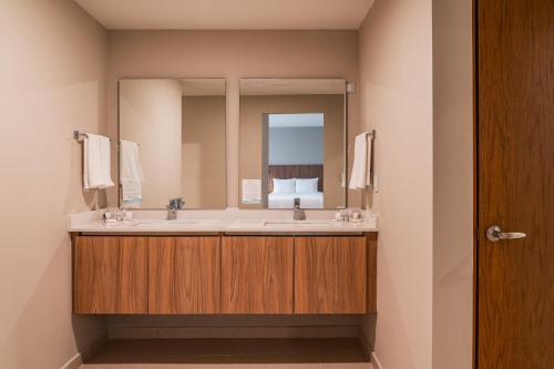 a bathroom with a sink and a mirror at Wyndham Garden Mazatlan Marina in Mazatlán