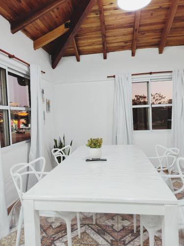 a white dining room with a white table and chairs at Apartamentos Mara - 100m de Termas in Federación