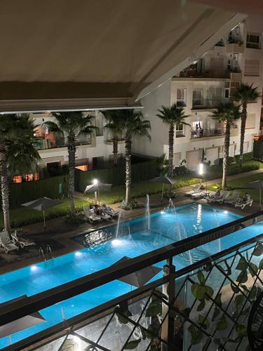a view from the balcony of a hotel with a swimming pool at Résidence kettani piscine bouznika in Bouznika