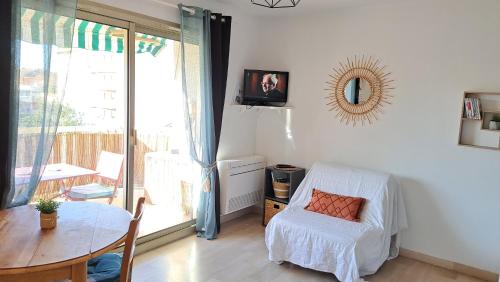 une chambre avec un lit, une table et une fenêtre dans l'établissement Le Palais Royal, à Saint-Raphaël