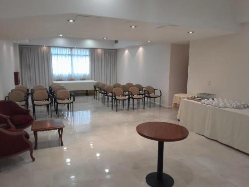 a room with chairs and tables and a room with a table at ATLAS TOWER HOTEL in Buenos Aires
