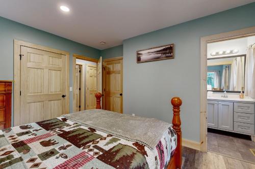 a bedroom with a bed and a bathroom at Kenny's Kabin in Wolfeboro