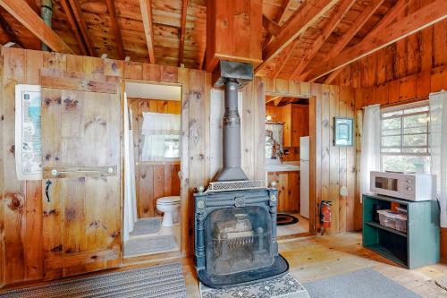 a living room with a woodburning stove in a house at Evergreen in Northport