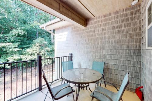 a patio with a table and chairs on a balcony at Townsend Timbers in Townsend