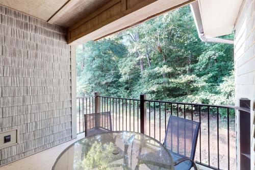 a balcony with a glass table and two chairs at Townsend Timbers in Townsend