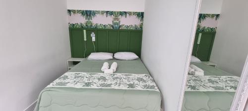 a small room with a bed with two rabbits on it at Iguassu Jungle Hotel pousada in Foz do Iguaçu