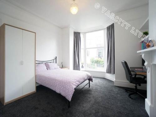 a bedroom with a bed and a desk and a window at East Lynne in Bangor