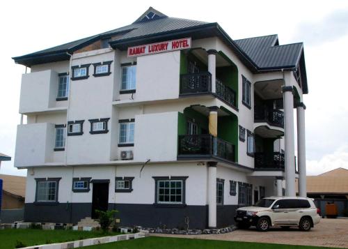 a white car parked in front of a building at Ramat Luxury Hotel in Mangpontin