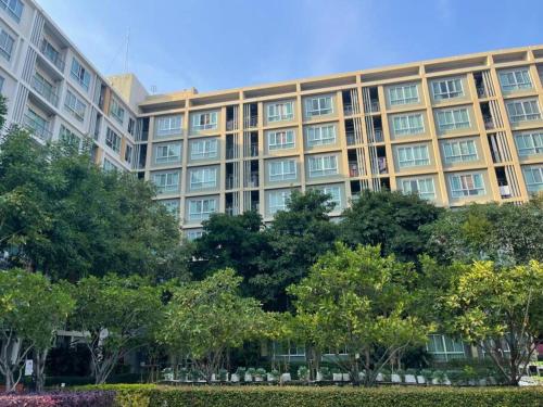 a large building with trees in front of it at D condo sign D4 in Chiang Mai