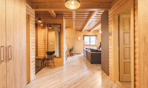 a hallway of a house with wooden walls at Restnest Vendégház: Infraszauna+Dézsafürdő in Dunasziget