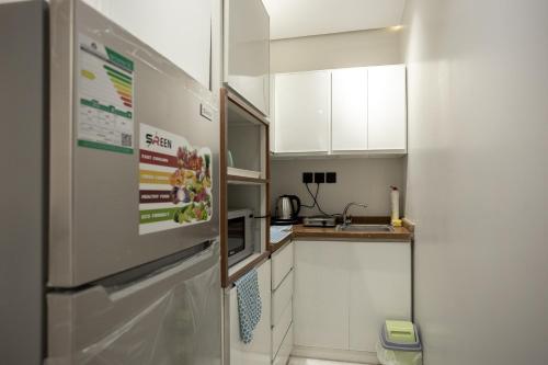 Kuchyň nebo kuchyňský kout v ubytování Dar Al-Naseem Apartments