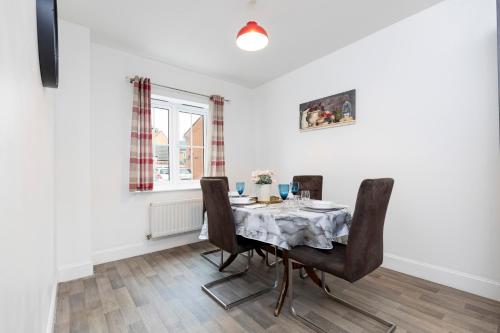 a dining room with a table and chairs and a window at Supreme House in Middlesbrough