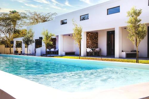 an image of a swimming pool in front of a house at Karoo Retreat- Self Catering Villas and Guest House in Oudtshoorn