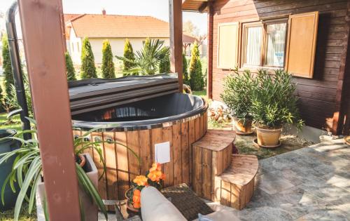 a hot tub in the backyard of a house at Restnest Vendégház: Infraszauna+Dézsafürdő in Dunasziget