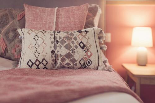 a pillow sitting on top of a bed next to a lamp at Ingleborough in Carnforth