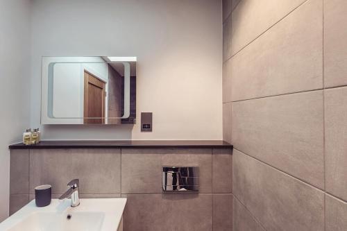a bathroom with a sink and a mirror at Ingleborough in Carnforth
