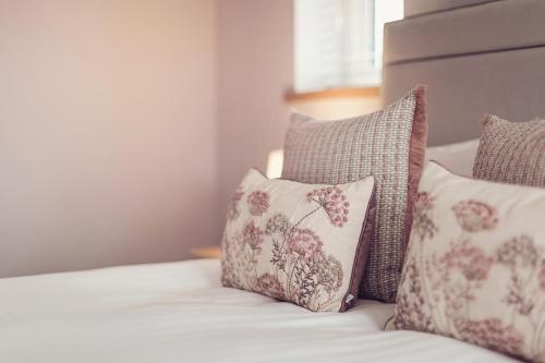 a group of pillows sitting on a bed at Ingleborough in Carnforth
