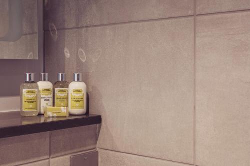 two bottles ofodorizers sitting on a shelf in a bathroom at Ingleborough in Carnforth