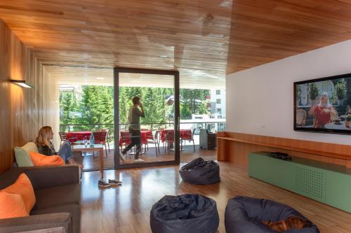 a living room with a person sitting on a couch at Bed & Breakfast Hotel Nives in Solda