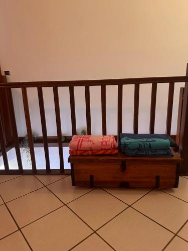 two bags sitting on a bench next to a railing at casa nonna Rica in Calcio