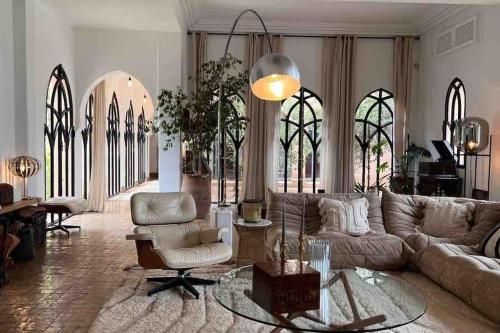 a living room with a couch and a chair at Villa d architecte Marrakech in Oulad Jellal