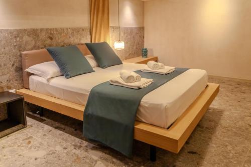 a bedroom with a large bed with towels on it at Residenza San Giovannello in Marsala